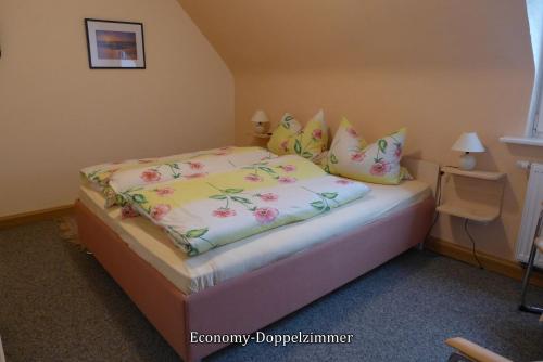 a bedroom with a bed with flowers on it at Pension Haus Linden in Winterberg
