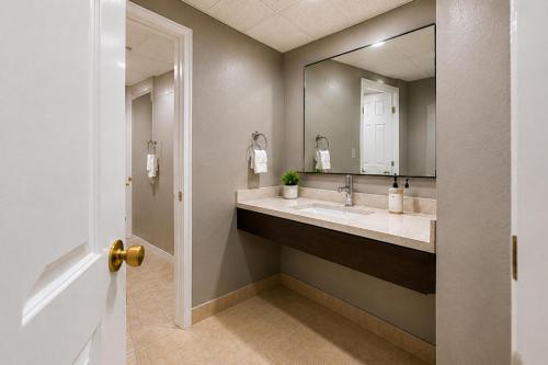 a bathroom with a sink and a mirror at Cumberland Inn By OYO New Cumberland-Hershey South in New Cumberland