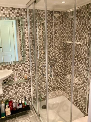 a bathroom with a shower with a glass door at На Видземском взморье Калнгале in Kalngale