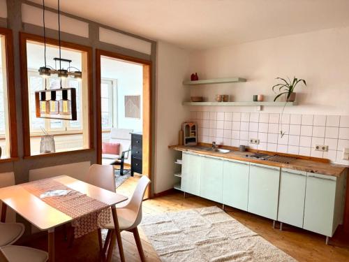 a kitchen with a table and a dining room at Idyllische Auszeit am Waldrand in Weiler