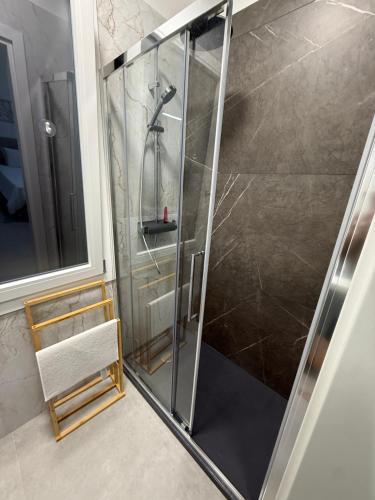 a shower with a glass door in a bathroom at Casa sissy in Chioggia