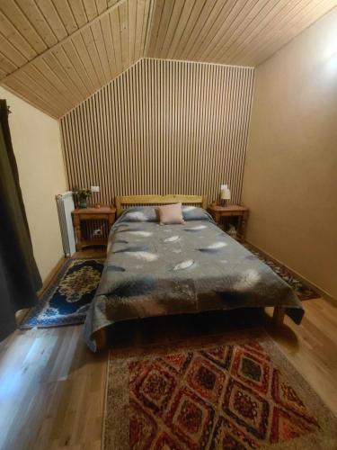 a bedroom with a bed and a wooden floor at Casa Maria in Cincu