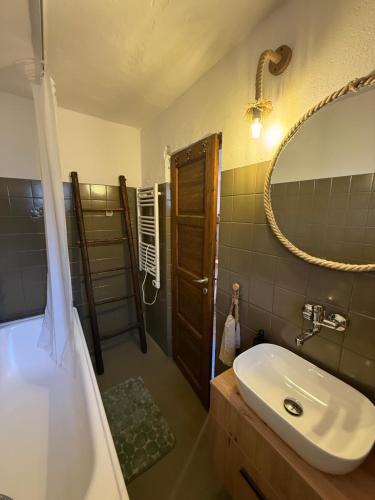 a bathroom with a sink and a shower with a mirror at Dvor u Hrivka in Heľpa