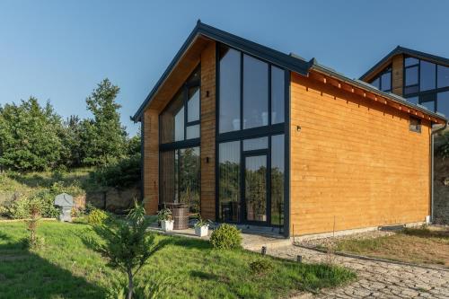 a house with glass and wood at Golden view Villa in Prishtinë