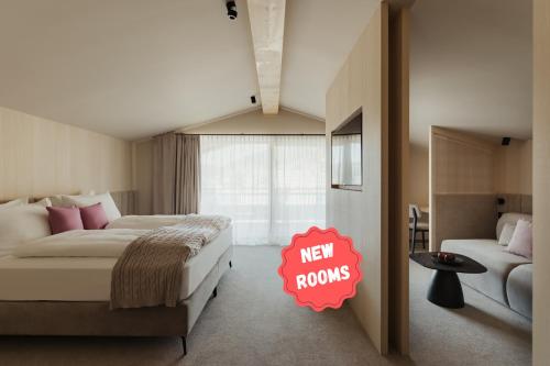 a bedroom with a bed with a new rooms sign on it at Hotel COSMEA - Your Dolomites & Honeymoon experience in Ortisei