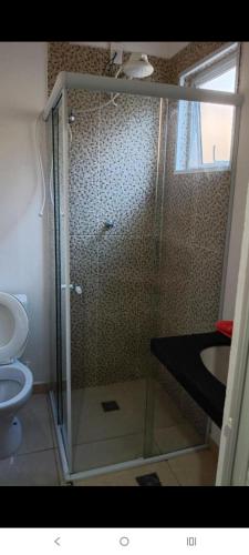 a bathroom with a shower with a toilet and a sink at Hostel Viracopos in Campinas