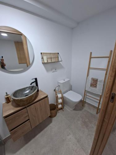 a bathroom with a sink and a toilet and a mirror at Refugio Bella Luna in Ruidera