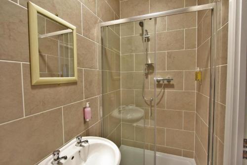 a bathroom with a shower and a sink at Central Hotel Gloucester in Gloucester