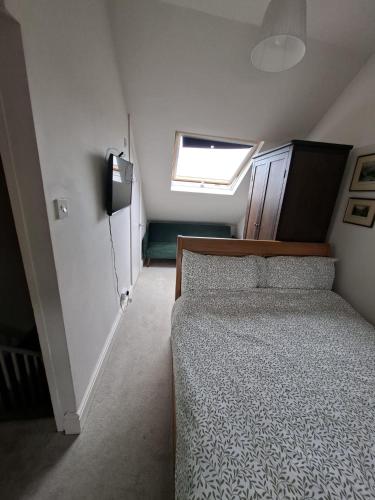 a small bedroom with a bed and a window at Castle Room in Windsor