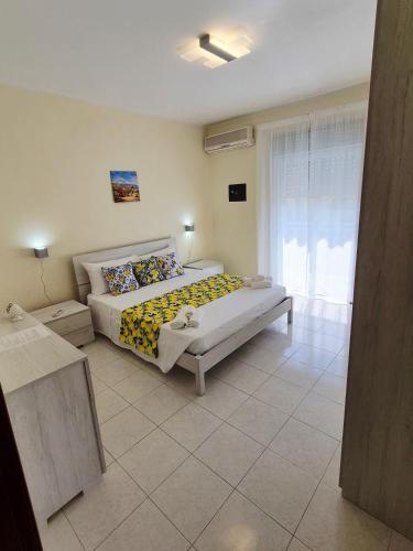 a bedroom with a large bed and a window at The Citrus Balcony in Trappitello