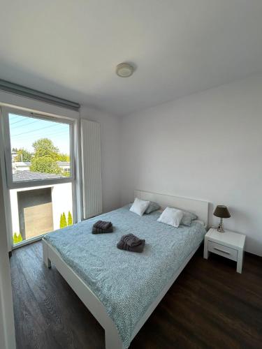 a bedroom with a bed with two towels on it at Cube Apartamenty in Lublin