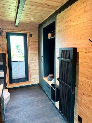 a room with a bathroom with a toilet and a window at Chalet Muckelstübchen in Bad Arolsen