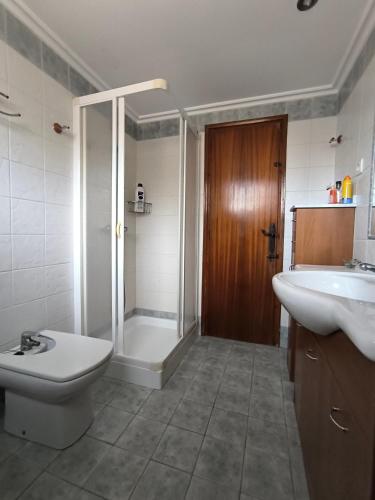 a bathroom with a shower and a toilet and a sink at Pedrera in Banyeres de Mariola