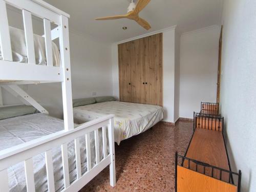 a bedroom with two bunk beds and a ceiling at Pedrera in Banyeres de Mariola