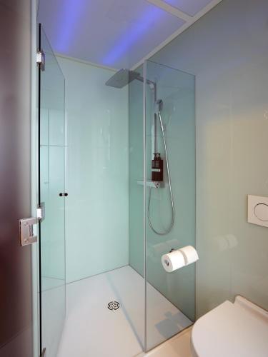 a glass shower in a bathroom with a toilet at citizenM Washington DC Georgetown in Washington, D.C.