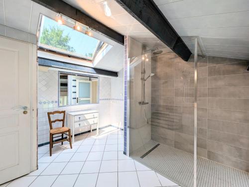 a bathroom with a shower and a glass shower stall at Clos de Beauregard in Cirière