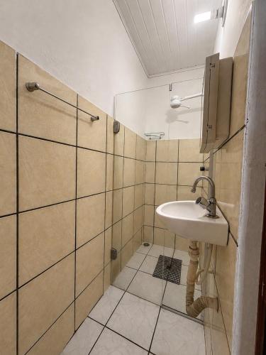 a bathroom with a sink and a shower at Pousada Gire in Itacaré
