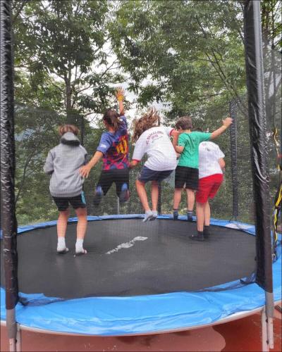 a group of girls jumping on a trampoline at Hotel Taüll in Pla de l'Ermita