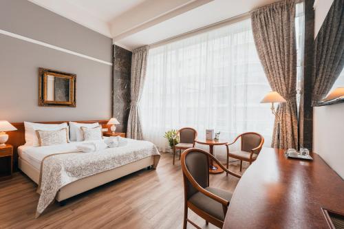 a hotel room with a bed and a table at Belvedere in Prague