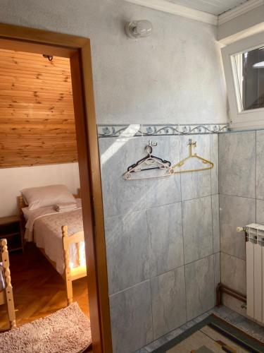a bathroom with a shower and a bed in a room at House Draga Plitvice near the lakes and bus stop in Plitvička Jezera