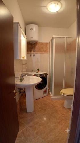 a bathroom with a sink and a toilet at Appartamento Eli in Valledoria