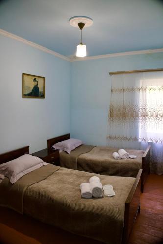 a bedroom with two beds and a window at BUJAKAN EcoTourism in Buzhakan