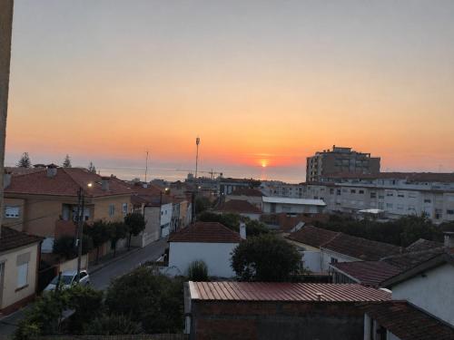 a view of a city at sunset at Sweets Suites Espinho in Espinho