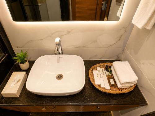 a bathroom with a white sink and a mirror at Jalsa Heritage- A Boutique Hotel in Jaipur