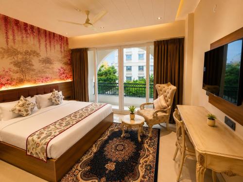 a hotel room with a bed and a television at Jalsa Heritage- A Boutique Hotel in Jaipur