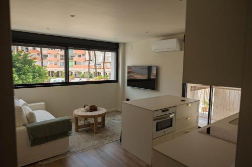 a kitchen and living room with a couch and a table at Amber Apartments in Jávea