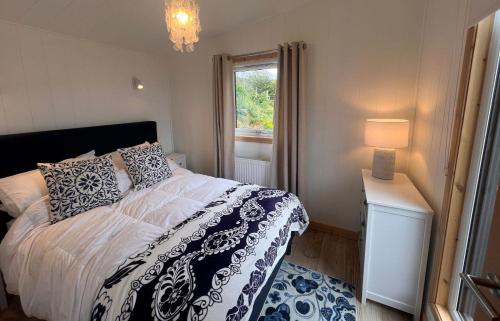 a bedroom with a bed and a window at Tiny Mara in Uig