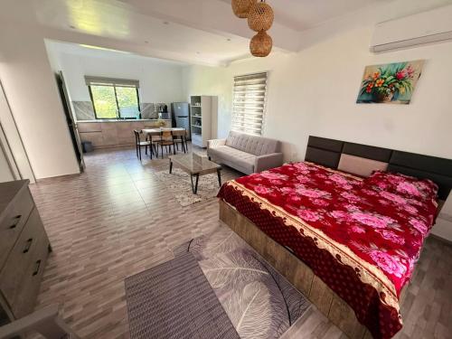 a bedroom with a bed and a living room at VR Villa in Trou d'Eau Douce