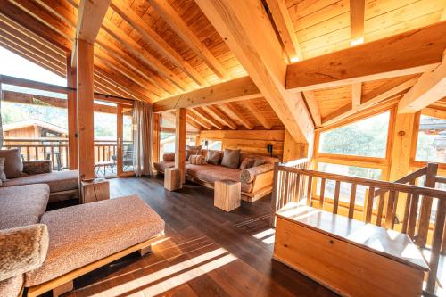 a large living room with wooden walls and ceilings at Chalet Namapa in Saint-Martin-de-Belleville