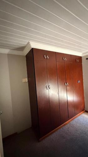a row of wooden cabinets in a room at Trendy Tranquility in Secunda
