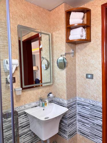 a bathroom with a sink and a mirror at 2RN SOLOMON Hotel and Spa 