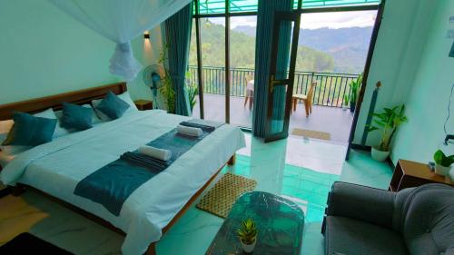 a bedroom with a large bed and a balcony at Blooming Hill Cabin Ella in Ella