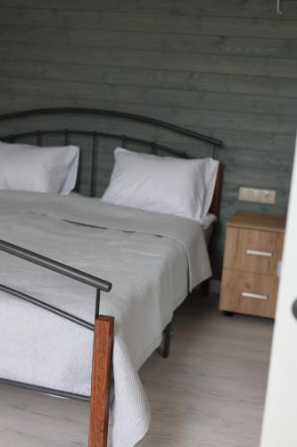 a bedroom with a bed and a wooden night stand at Sunny Home in Ijevan