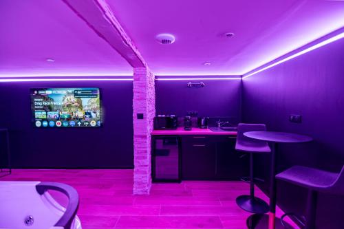 a purple room with a bar with purple lighting at Cristal Room in Rochefort
