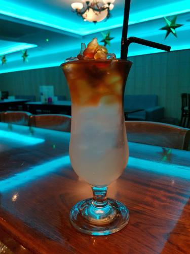 a drink sitting on top of a wooden table at Caisleain Oir Hotel in Annagry