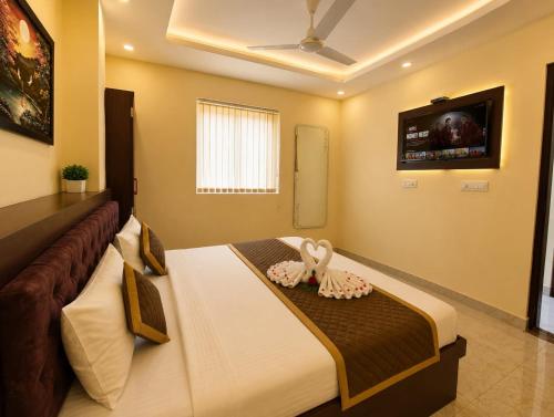 a bedroom with a bed with two stuffed animals on it at Hotel Sunny in Varanasi