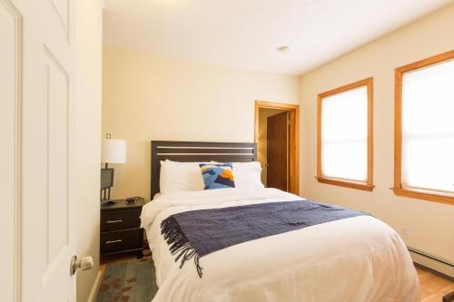 a bedroom with a large bed and a window at 1 Bedroom Apartments Near Kendall Square in Cambridge