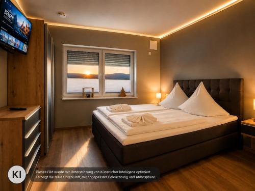 a bedroom with a large bed and a television at Eastside Braunlage in Braunlage