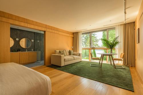 a bedroom with a couch and a table in a room at Park Hotel Kenmare in Kenmare