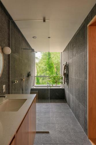 a bathroom with a sink and a bath tub at Park Hotel Kenmare in Kenmare