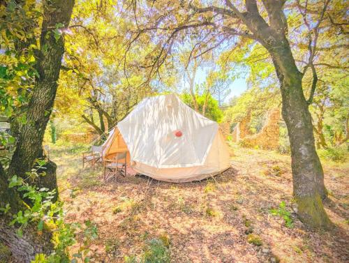 a tent in the middle of a field with trees at Grignan Glamping 2 -4 people exceptional view in Réauville