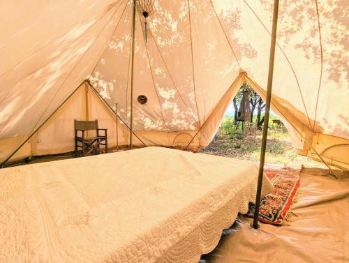 a tent with a table and a chair in it at Grignan Glamping 2 -4 people exceptional view in Réauville