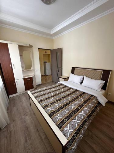 a bedroom with a large bed in a room at Hotel Dilijan Old Center in Aghk'ilisa