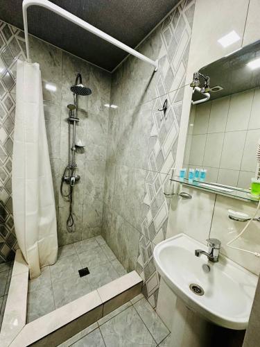 a bathroom with a shower and a sink at Hotel Dilijan Old Center in Aghk'ilisa