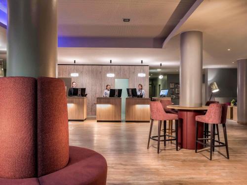 eine Lobby eines Hotels mit Menschen, die an ihren Computern arbeiten in der Unterkunft Mercure Hotel München Neuperlach Süd in München
