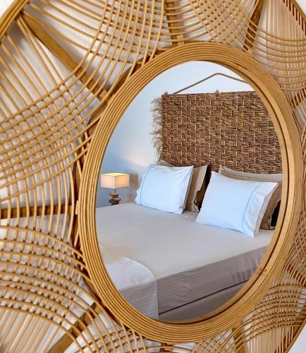 a bedroom with a large mirror over a bed at Aspro Mple in Astypalaia